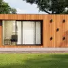 “Contemporary tiny modular home with wood-panel exterior and large windows, set in a green landscape under blue skies.”